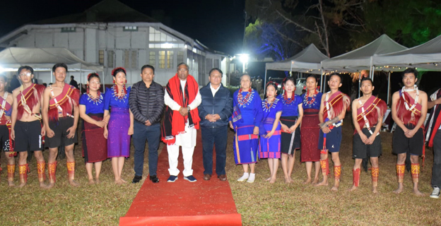 Minister of State for Steel and Rural Development, Faggan Singh Kulaste with Nagaland Minister of RD and SIRD, Metsubo Jamir, and Deputy Commissioner of Mokokchung Thsuvisie Phoji, flanked by a cultural troupe at his ‘At Home’ reception on 14 February.